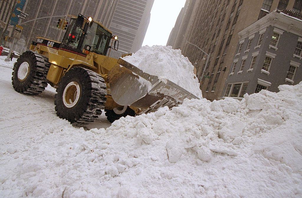 Dump truck removes snow along Sixth Ave. the day after a blizzard.