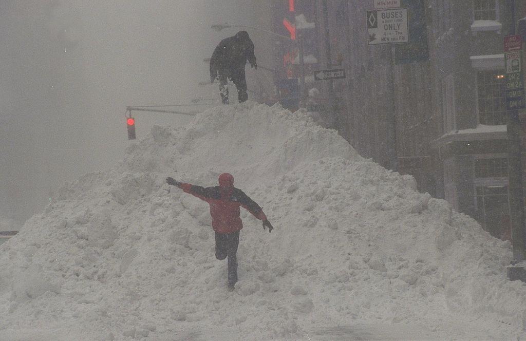 Children climb up 30-foot piles of snow along the streets and sidewalks of Manhattan after a blizzard.