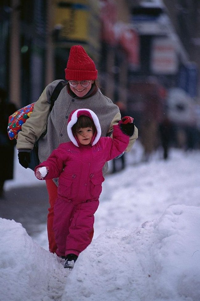 Mother and Daughter Walking Through Snow