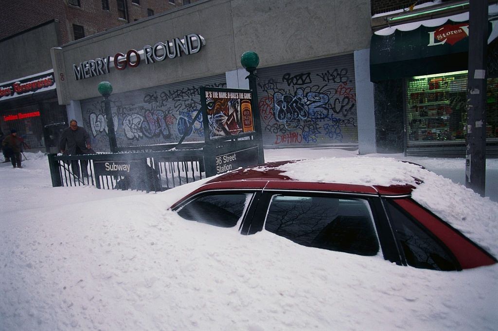 Car on City Street Buried in Snow