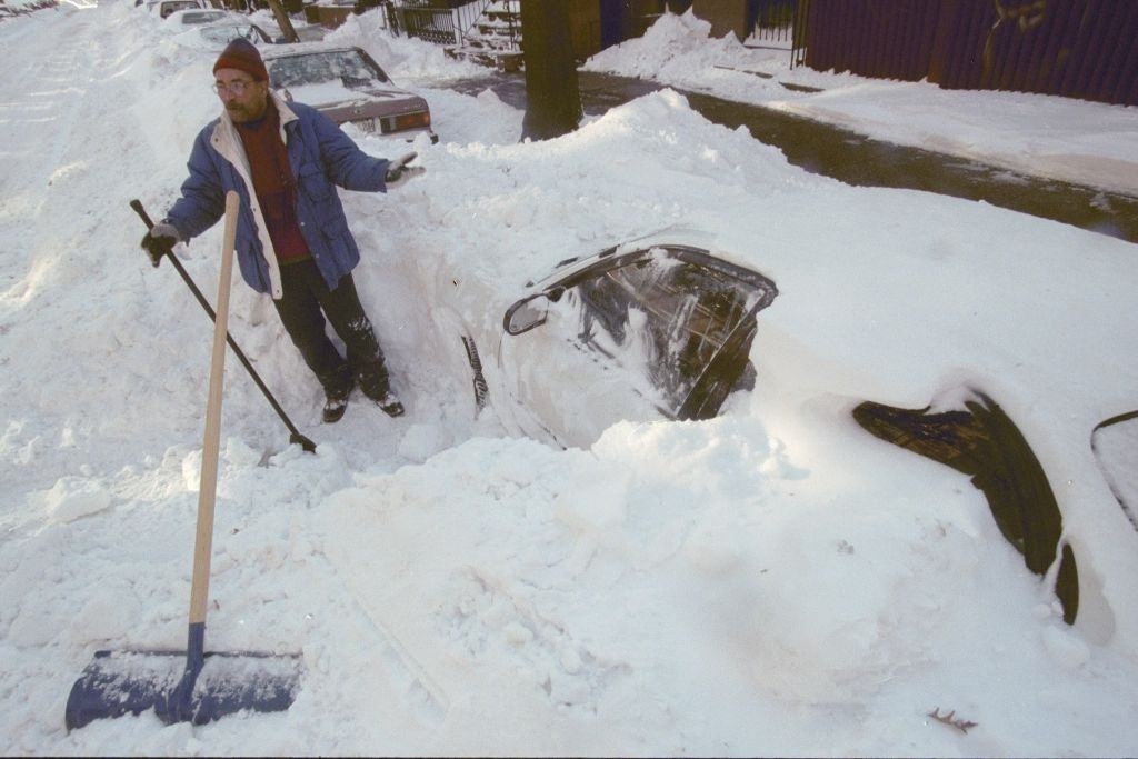 Earl Lessey starts digging one of his two cars out of the snow in Carroll Gardens after a blizzard left them buried.