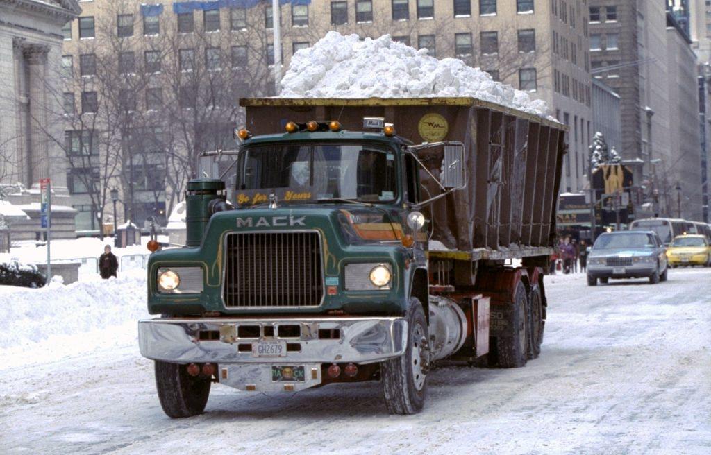 Dump truck heads down Fifth Ave. with a load of snow to be dumped into the East River after a blizzard.