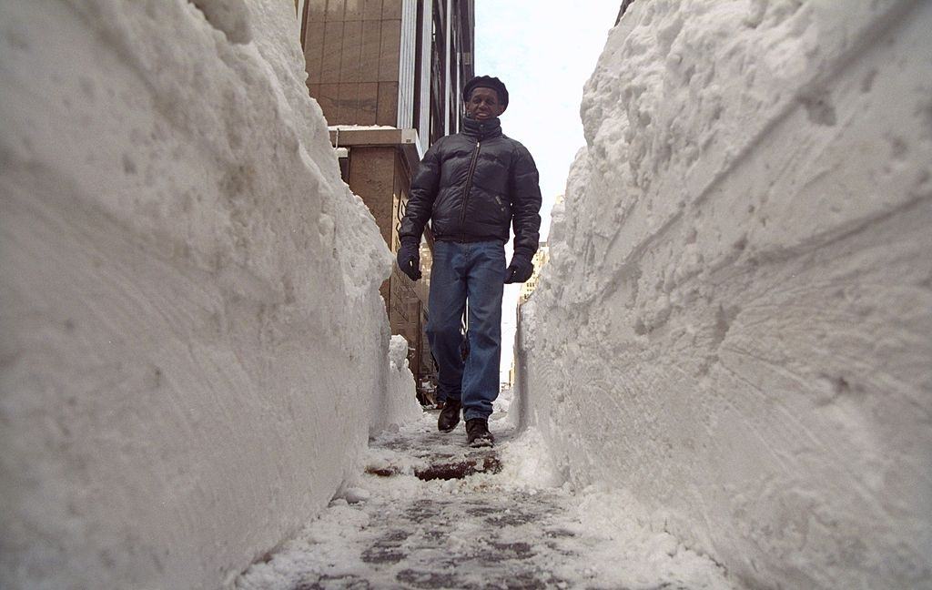 Huge tunnels dug out of the snow allow New Yorkers to get onto sidewalks as they head back to work after a blizzard.