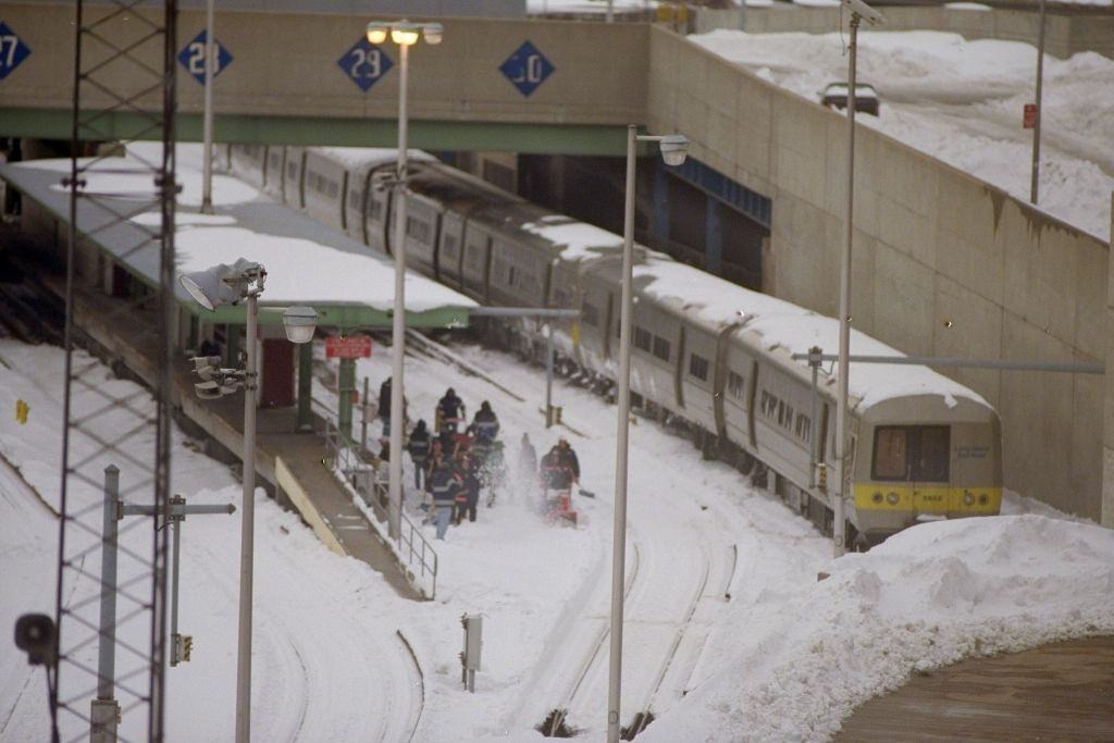 Workers remove snow from train tracks after a blizzard, at the John D. Caemmerer Westside Storage Yard Complex of the L.I.R.R.