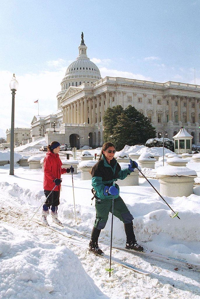 Jennifer Pitt (right) and Ann Crystal make their way past the U.S. Capitol on skis, since a large amount of snow remains on the ground as a result of a blizzard.