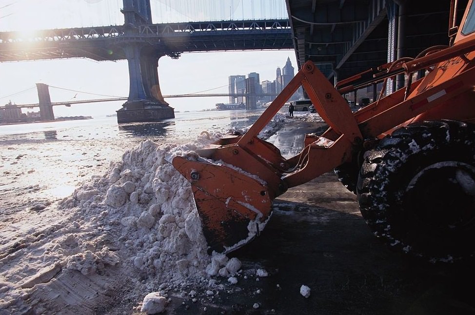 Bulldozer Dumping Snow in River