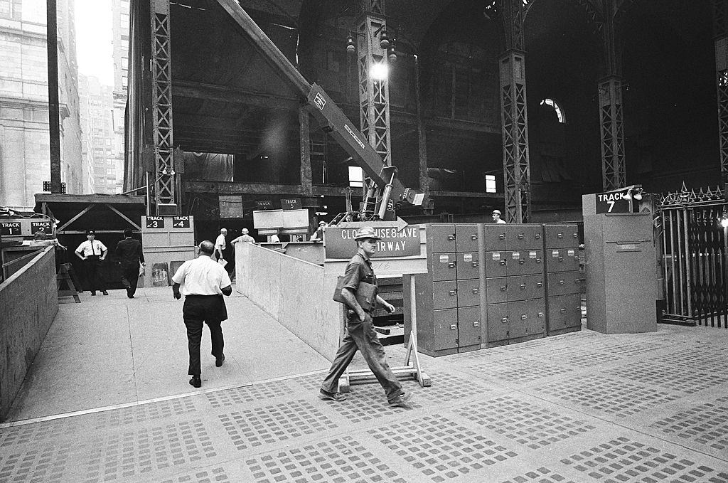 Commuters on their way through a cordoned off-center section of the main floor (at left) during the station's demolition, 1965