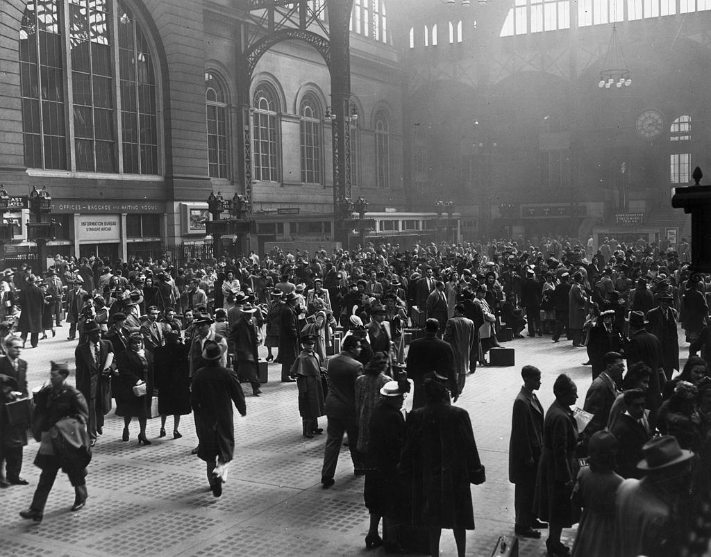 View of a crowd of people in the interior of the old Pennsylvania Rail Road Station, New York City, 1950