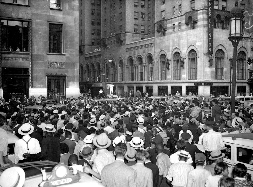 Crowd outside Pennsylvania Station wait to see Scottsboro boys, 1940