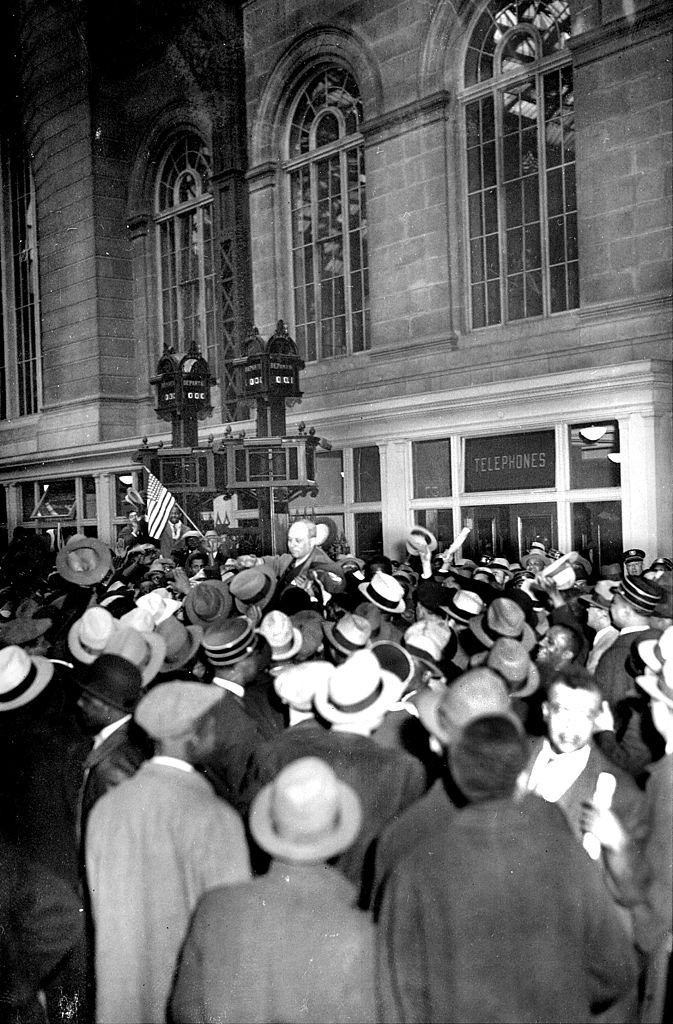 A cheering, milling crowd carries Samuel, 1933