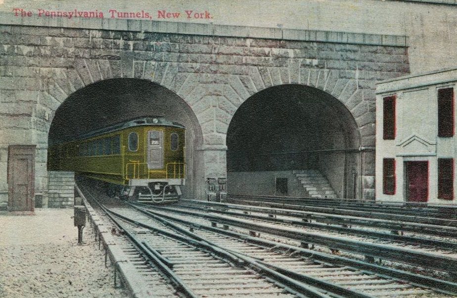 An electric engine exiting one of the tunnels at Pennsylvania Station, New York City, published by Success Postal Card Co, 1912.