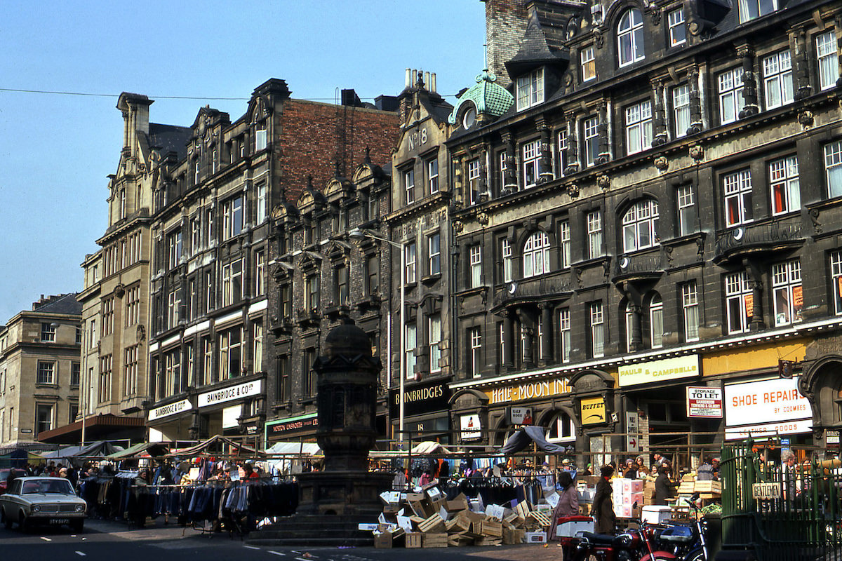 Newcastle Bigg Market in 1976, with open air market stalls in the foreground