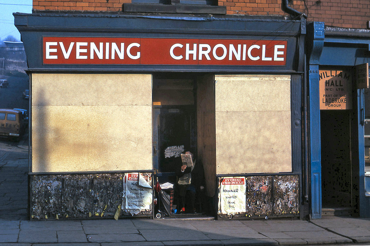 The ‘Evening Chronicle’ seller in an apt sheltered spot in Byker in 1975.