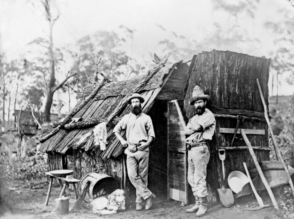 Gold miners outside a bark hut, Queensland, 1870
