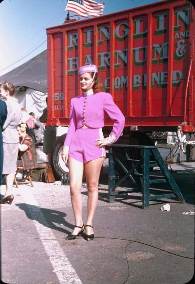 A ‘circus beauty’ in pale lavender cap, coat and shorts