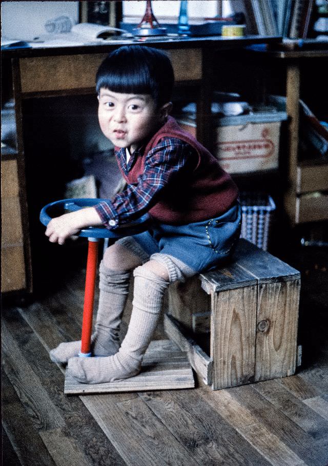 Young boy playing with a steering wheel