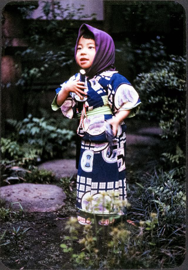 Little girl in a kimono and head scarf