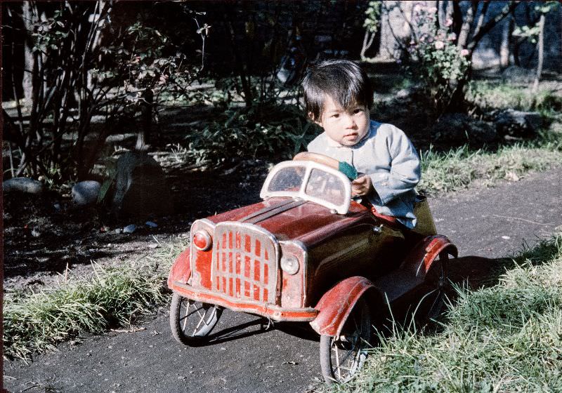 Boy driving a metal toy car