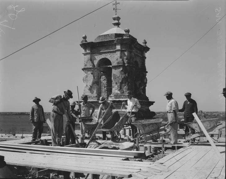 Workmen pouring the last of the concrete on the dome of San Jose Mission during a restoration program, 1935