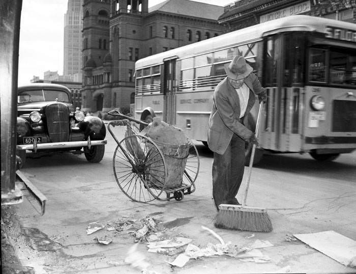 Felesfora Benavides sweeping street after 1937 Battle of Flowers Parade, 1937