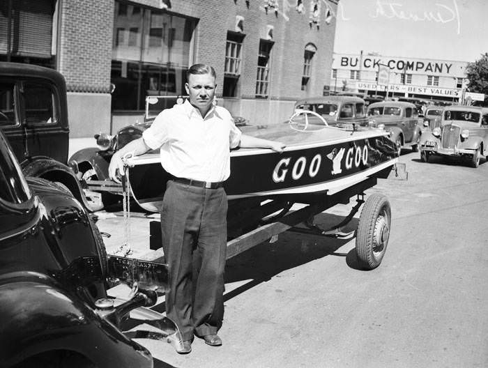 Kenneth Savage standing beside his speed boat, Goo-Goo, 1937
