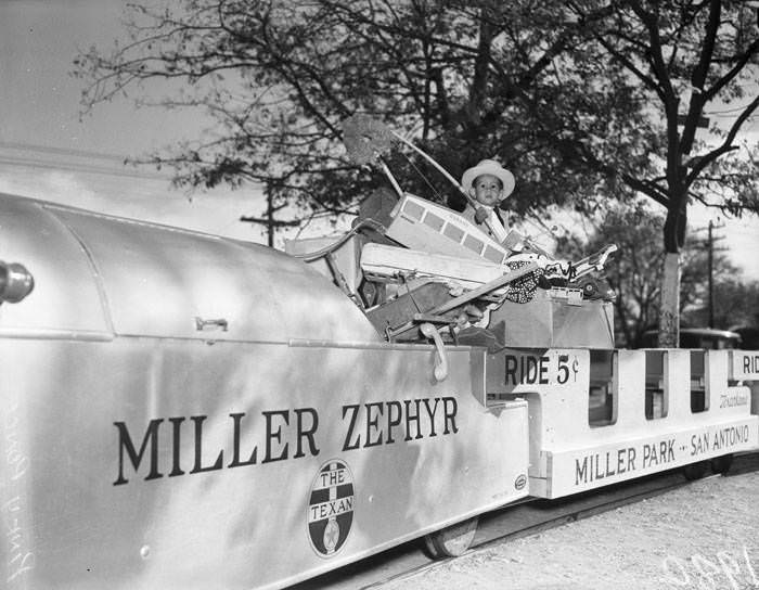 Pinky Ponce on top of train full of donated toys at Miller Park, 1938