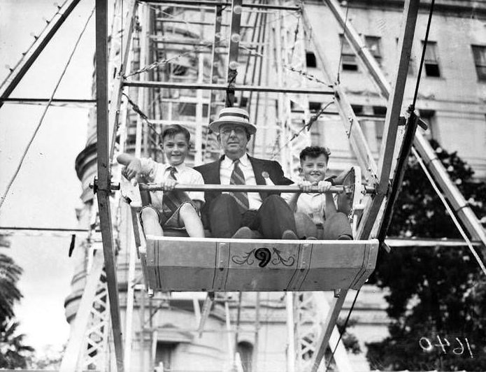 John Williams and children on ferris wheel at 1938 Fiesta Carnival, 1938