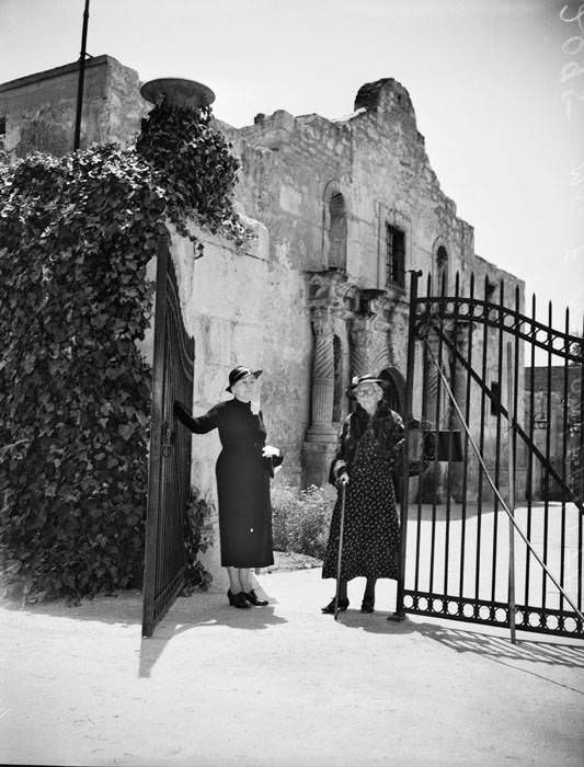 Mrs. J.A. Petty and Mrs. Fannie Applewhite posed beside the Alamo gate, 1939