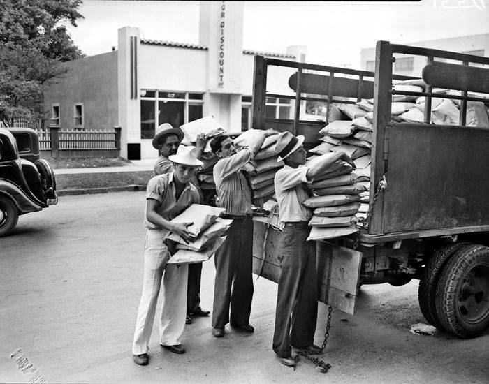 Street vendors unloading cushions for the 1937 Battle of Flowers Parade, 1937