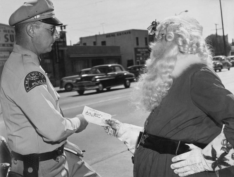 Santa Claus gets a traffic ticket, Maywood, California, 1952.