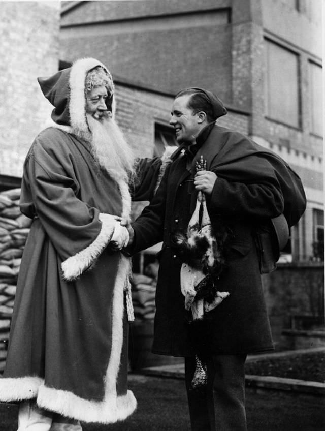 A man dressed as Father Christmas shaking hands with a soldier, 1940