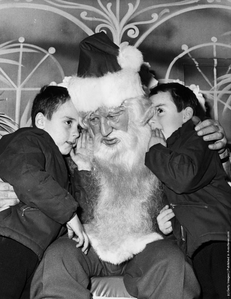 A pair of five year old twins tell Father Christmas what they want for their presents at Selfidges in Oxford Street, 10th December 1970