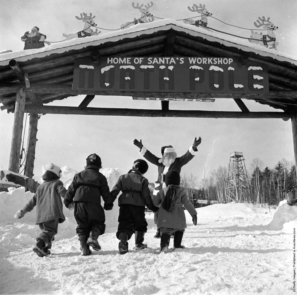 Santa Claus welcomes young visitors to his North Pole Workshop in the Adirondack Mountains of New York State, 1955