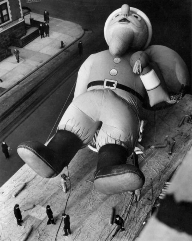 A 45-foot Santa Claus inflated for the Macy's Parade, New York, 1940. (Weegee)