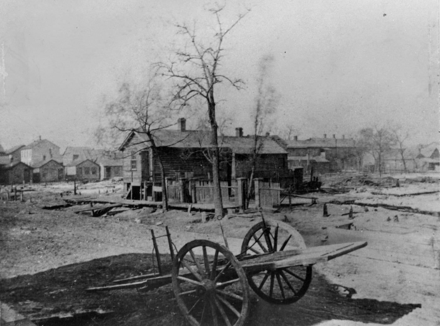 In this photo taken shortly after the Great Chicago Fire of 1871, the O'Leary house, center, still stands, but only rubble is left of its barn, right.