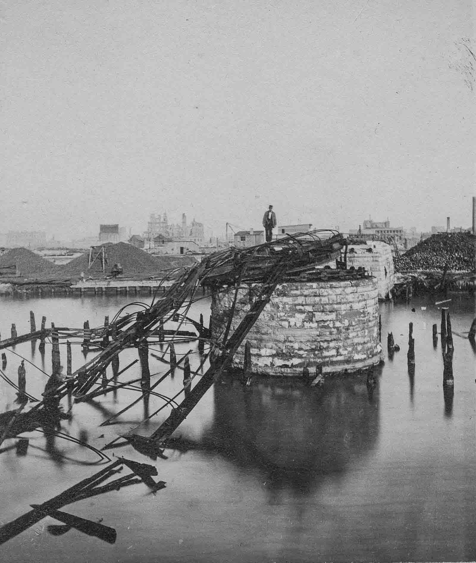 A man stands on the remains of the Van Buren Street Bridge.