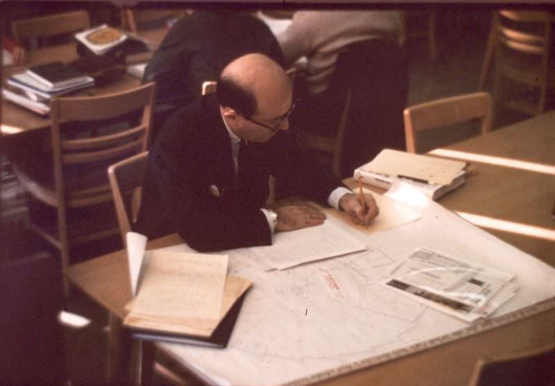 Library Director, William Joyce, examining floor plans for the planned LRC building (opened 1971), December 1969