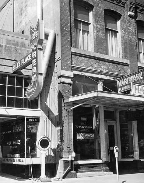 Bill's Place ice cream and hardware shop fronts showing earthquake damage, Olympia, April 1949
