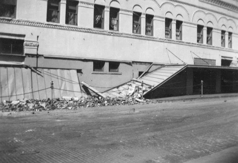 Damaged building canopy in downtown Olympia after an earthquake, April 1949