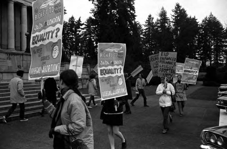 Demonstrators holding signs at abortion rights rally in Olympia, 1970