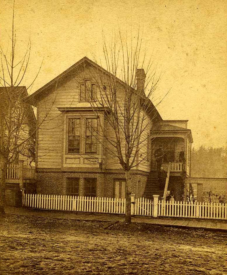 Waughop House and residents on Main St. (now Capital Boulevard) between 5th & 6th (now Legion), Olympia, 1877