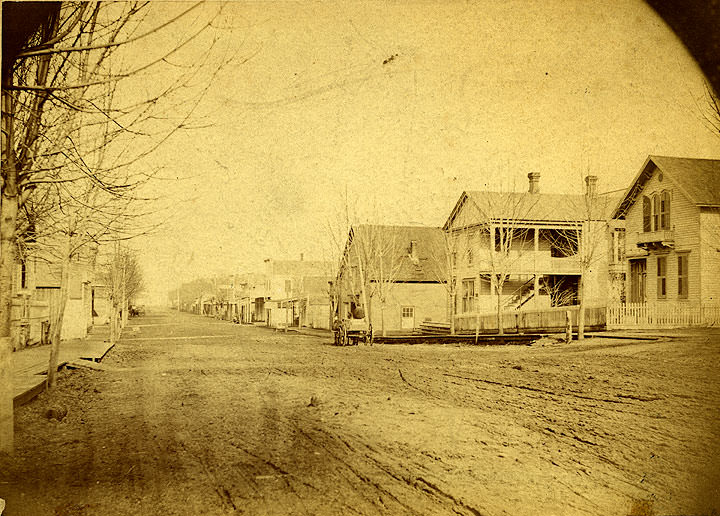 Wide dirt street identified as Main Street (now Capitol Way), Olympia, 1876