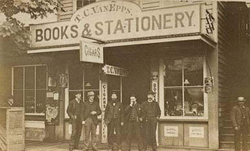 A one-story wooden building identified as the T.C. Van Epps Books and Stationery Store, Olympia, 1876.