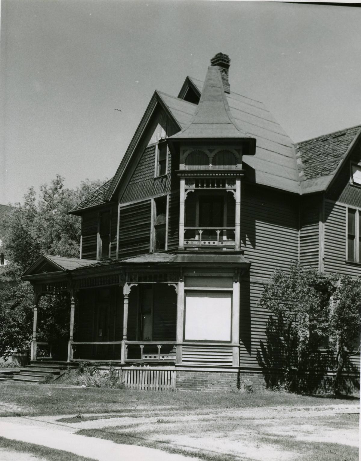 Three-story wooden house with gingerbread trim on corner and porch in 2nd Avenue, Spokane, 1968