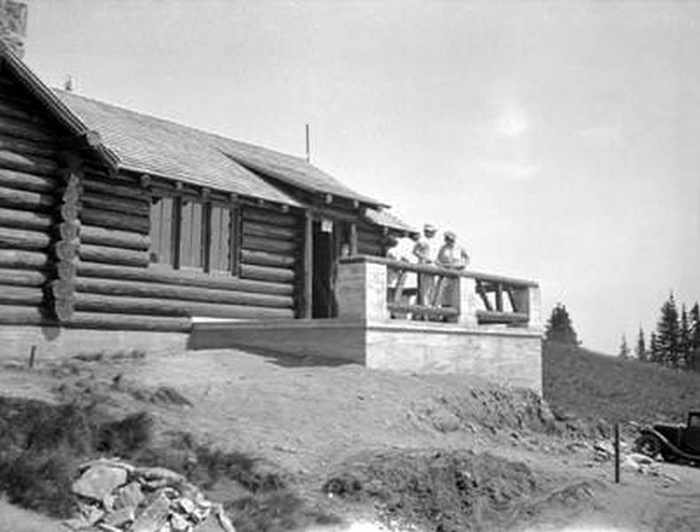 People in front of log building in Mount Spokane State Park, 1930s