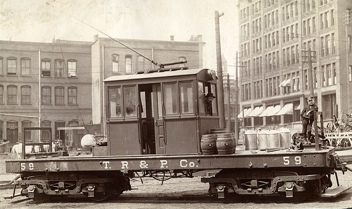 Flat working car of the Tacoma Railway and Power Company stopped on Pacific Street in Tacoma, 1902