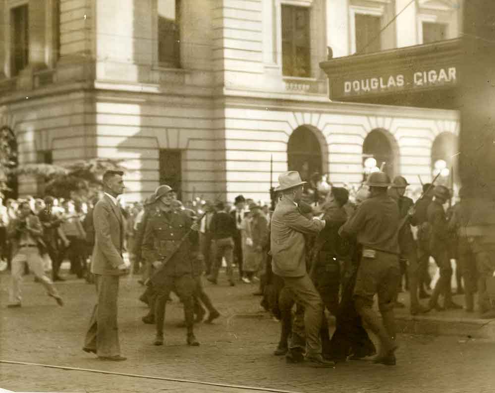 Sawmill workers' strike. Chief Harold Bird in a gray suit and Chas. MacEchraen, 1935