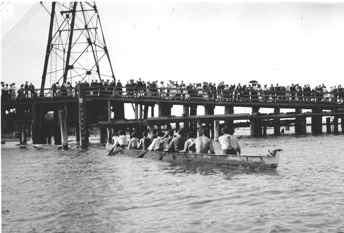 Two long canoes racing in the Deschutes Estuary, Olympia, 1905