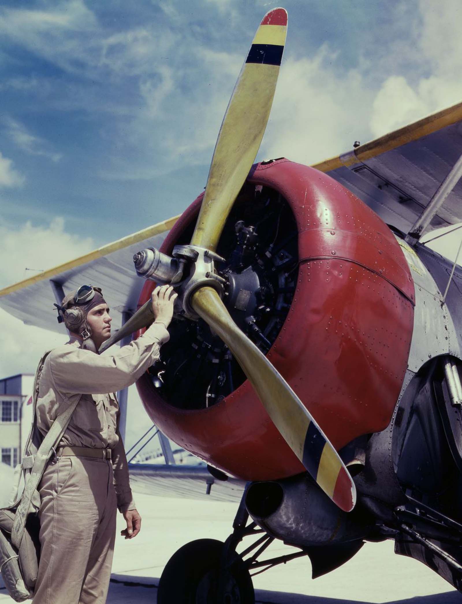 Aviation Cadet Thanas inspects an airplane engine.