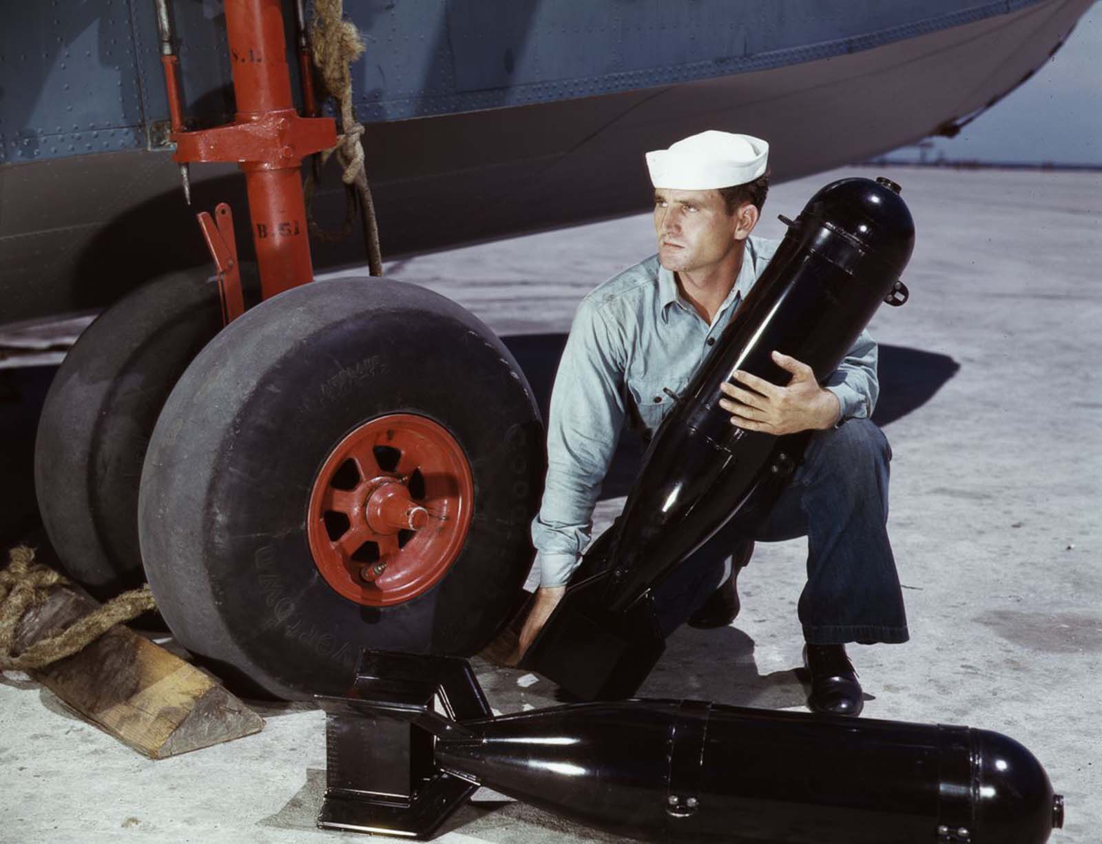 J.D. Estes loads munitions into a plane.